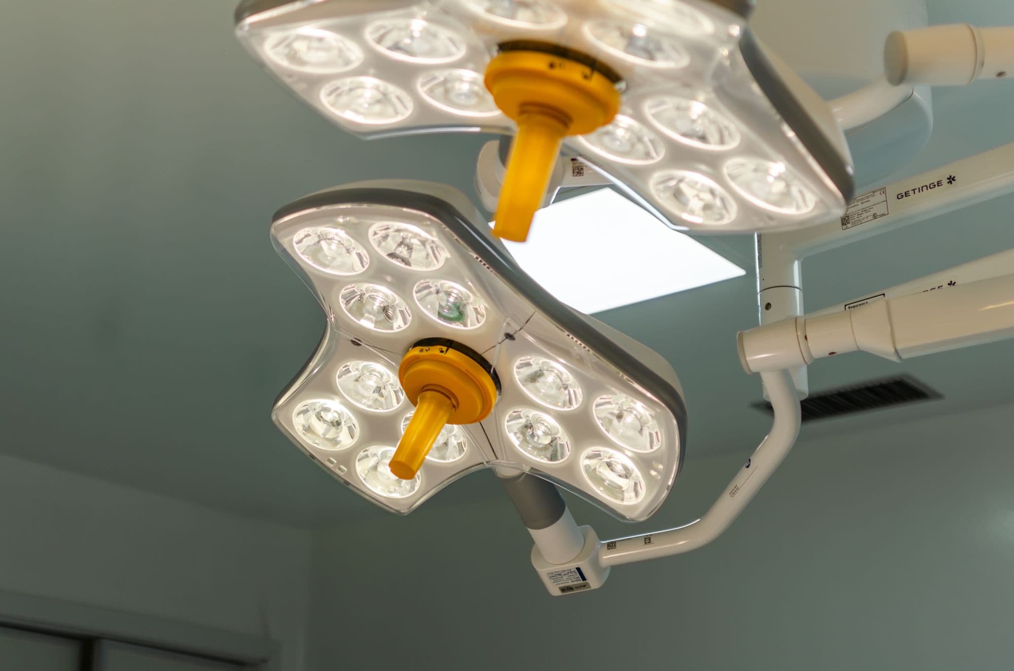 Twin operating theatre lights above a surgical table