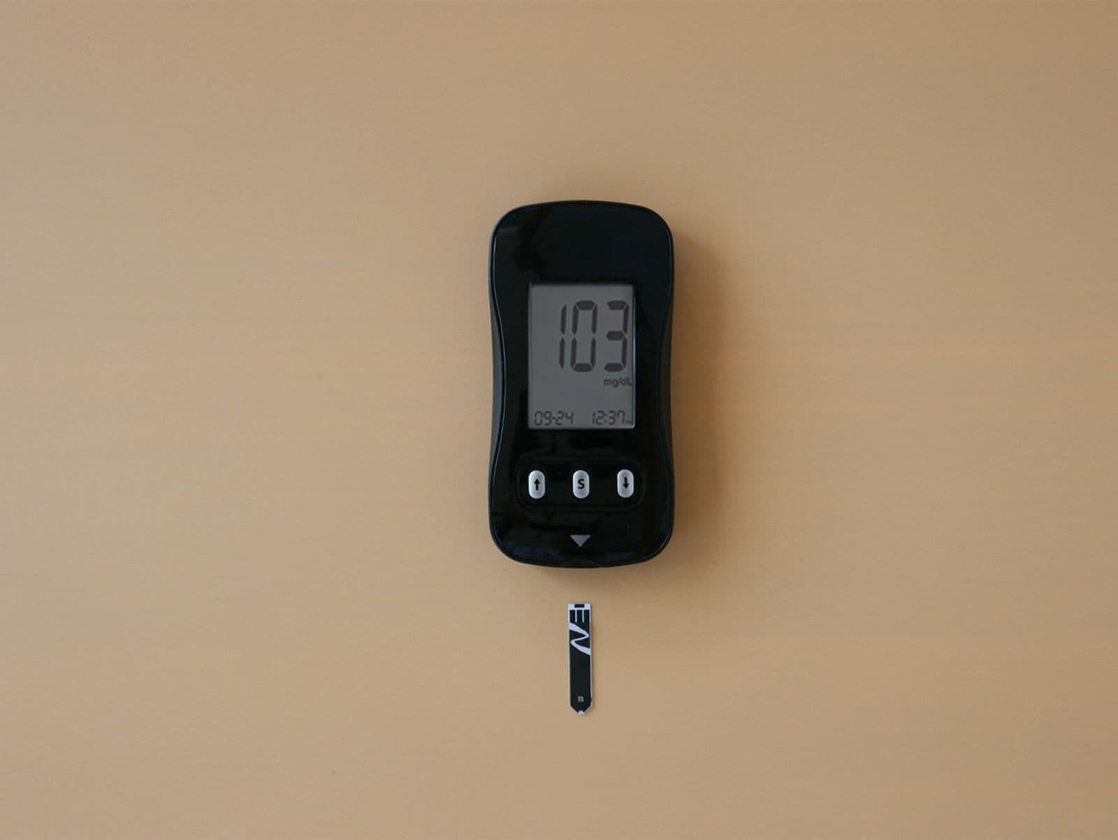 A digital blood glucose meter displaying a blood sugar reading