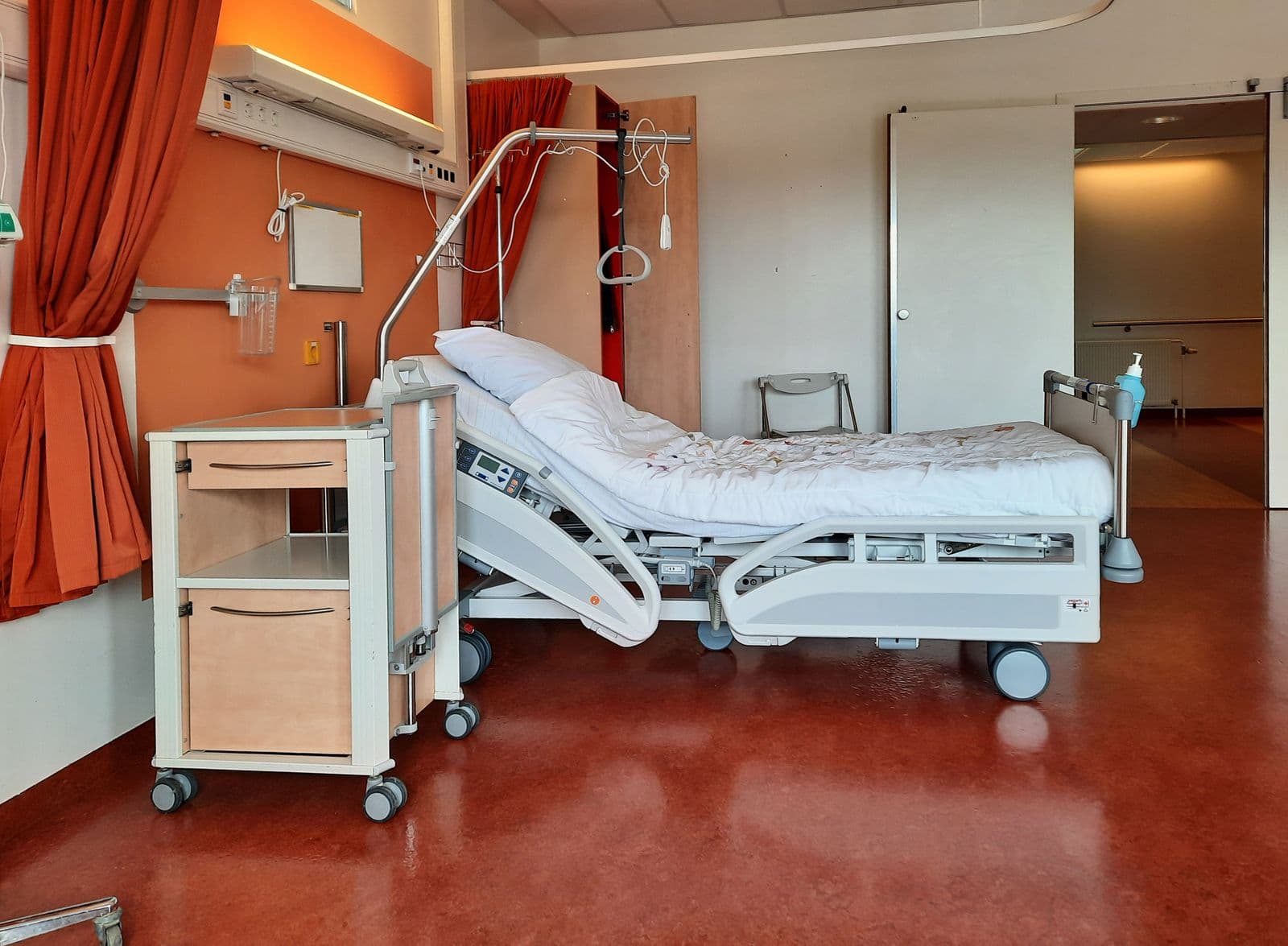 A clean, modern hospital room with an adjustable bed