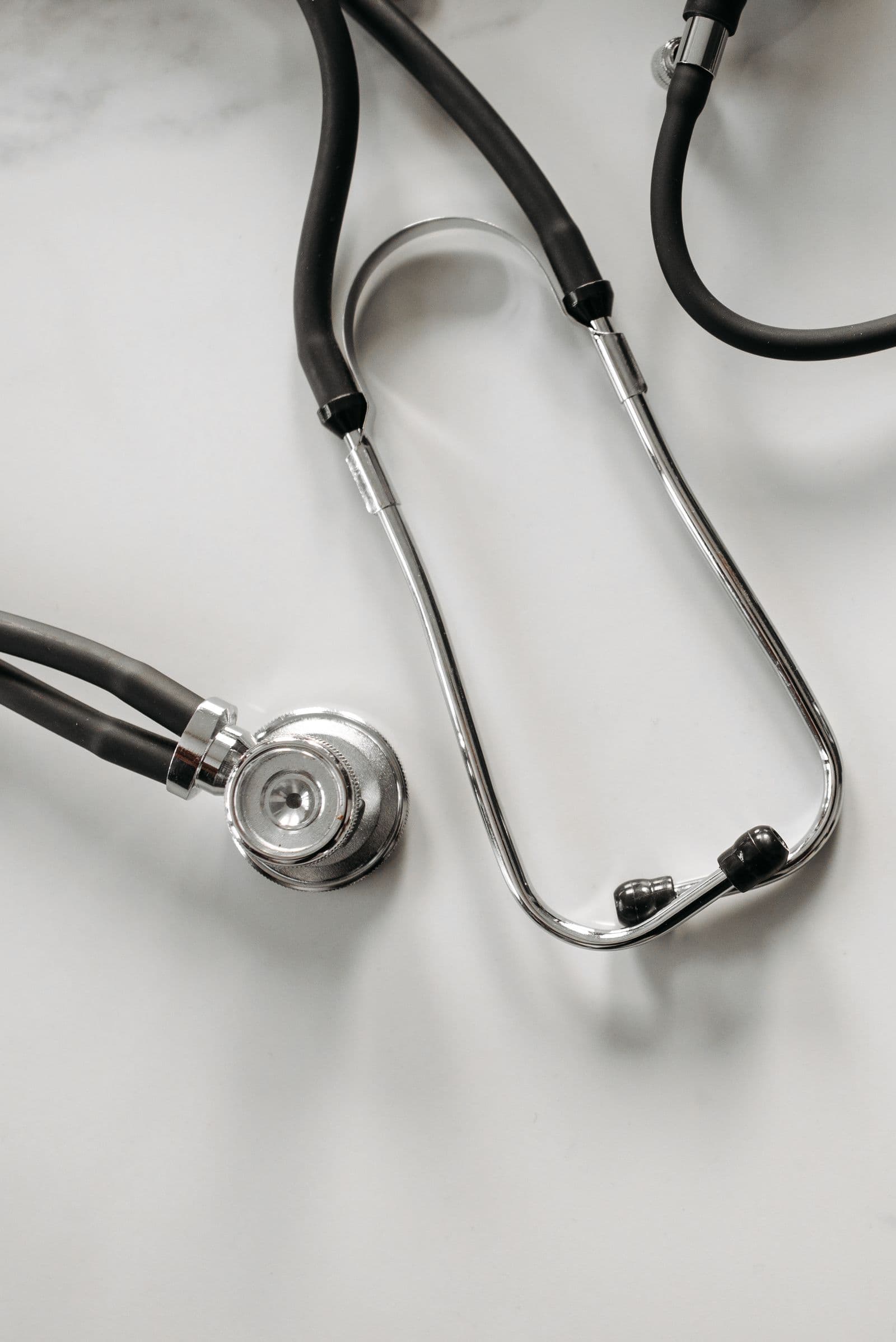 A stethoscope resting on a light marble surface