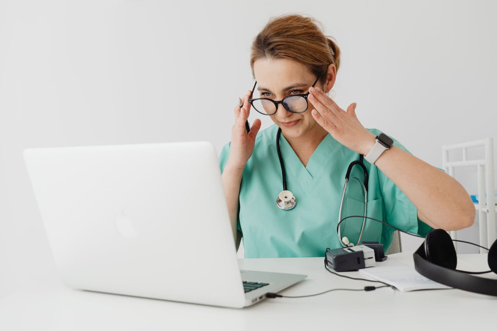 A clinician using a laptop for a video consultation